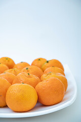 tangerine on a white background. How to choose, store and how much you can eat so as not to harm the body.	
