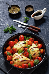 caprese chicken in black baking dish, top view