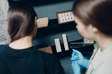 Young woman doing ear piercing at beauty studio salon