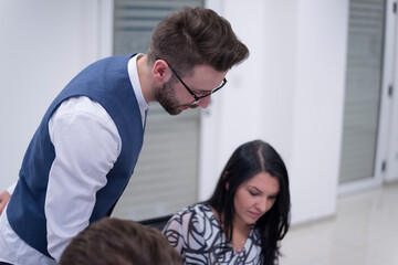 Teacher Giving Lesson to Diverse Multiethnic Group of Female and Male Students in College Room