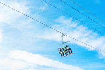 Ski Lift with a Group of Skiers against Blue Sky