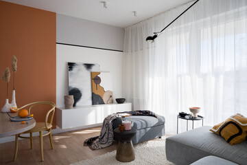 Bright living room with orange wall