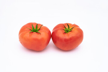 Two tomatoes on white background