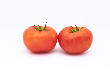 Two tomatoes on white background