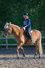 Fototapeta premium Woman horseback riding 