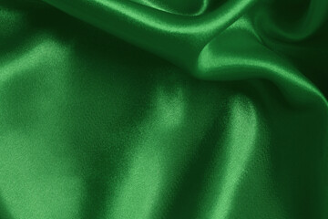 Dark green fabric cloth texture for background and design art work, beautiful crumpled pattern of silk or linen.