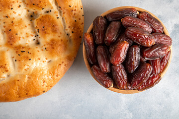 Date fruits,traditional ramadan pita on bright background,top view