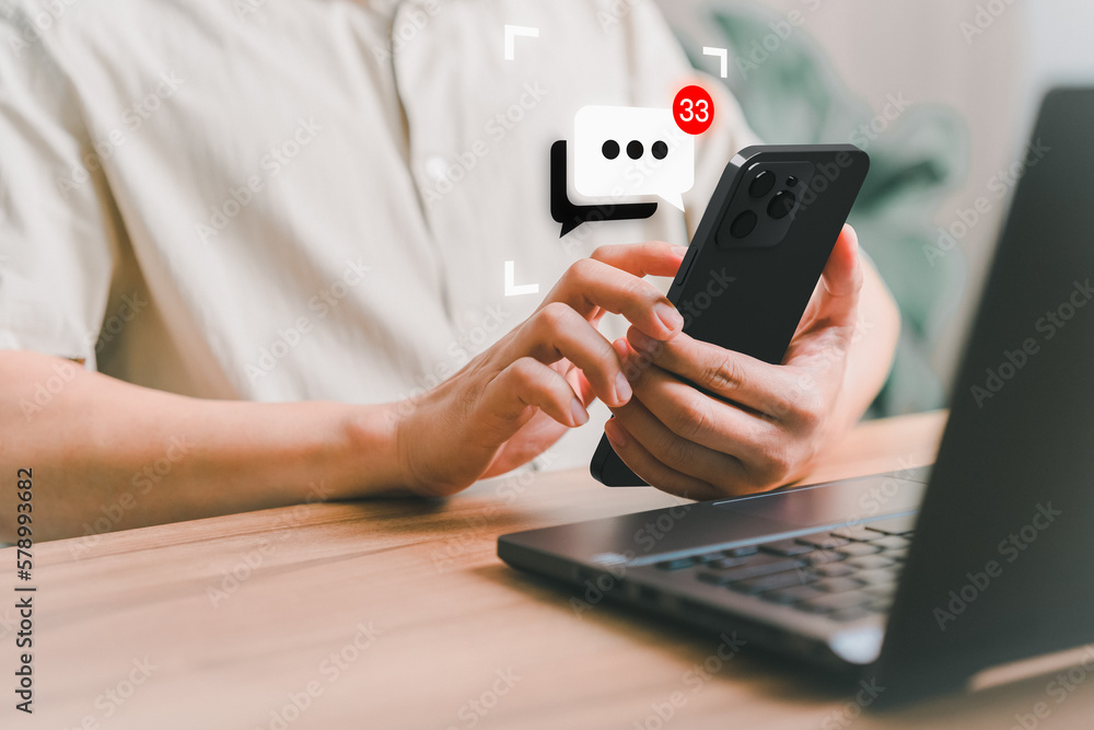 Aufkleber Young man hand using a smartphone typing live chat chatting on application communication speech bubble digital web and social network concept. Social media application chat box on mobile phone.