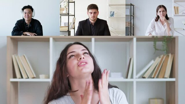 Group video chat. Online interview. Online communication. Excited woman speaking to skeptic diverse business team at digital office.