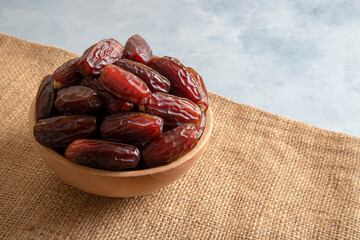  Date fruits in wooden bowl,top view

