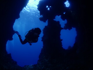 scuba diver cave dive underwater exploring blue caves ocean scenery