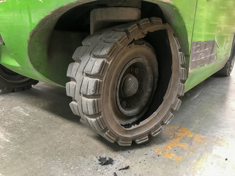 Close up photo of broken solid tire of a forklift.