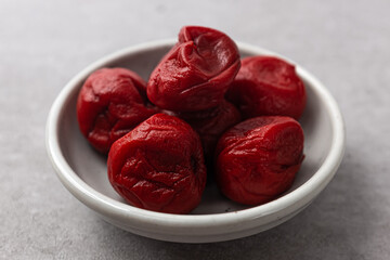 Sweet and salty umeboshi with salted chinese plums - obrazy, fototapety, plakaty