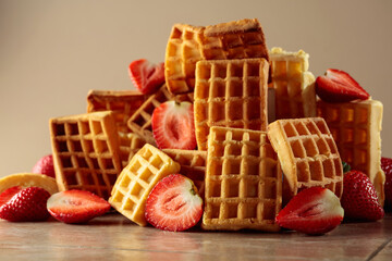 Belgian waffles with strawberries on a beige background.