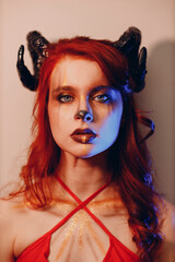 Beautiful young woman with makeup zodiac signs of Capricorn or Aries or Taurus. Girl with horns on head.