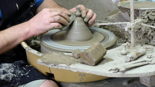 Video of potter's hands who makes the small vase on the potter's wheel. Crete