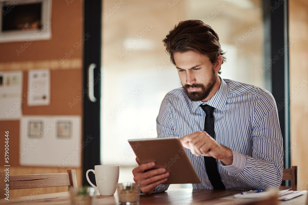 Poster putting in late hours online. a businessman using a digital tablet.