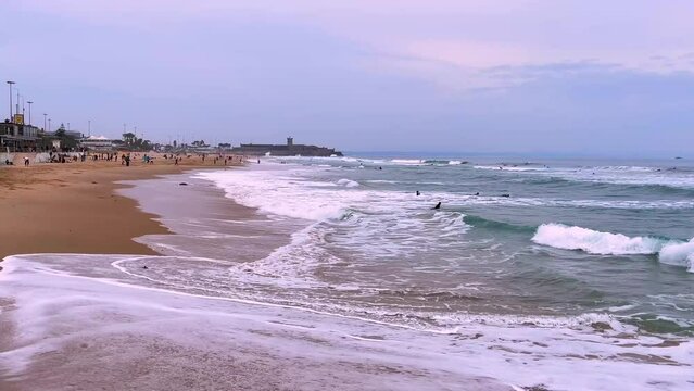 Scenes of surfers from all over the world coming together to share their love for the sport and the ocean at Carcavelos