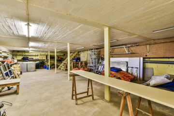 the inside of a building that is being used as a workshop for woodworking and other things to work...