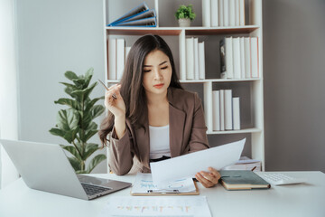 Asian businesswoman in formal suit in office happy and cheerful during using smartphone and working