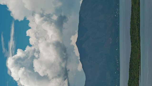 Huge clouds in a dynamic cloudscape over Mount Dore - time lapse in vertical orientation
