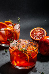 Red cocktail with bloody oranges with ice cubes. Summer refreshing cocktail