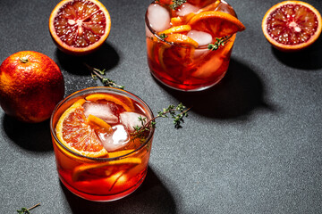 Aperitif alcohol cocktail ice and Sicilian red oranges. Summer refreshing cocktail, place for text,...