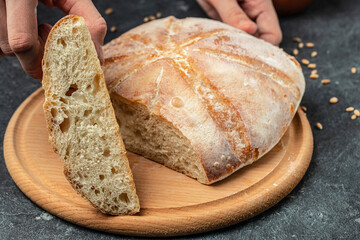 Female hands holding Homemade sourdough bread. Culinary, cooking, bakery concept