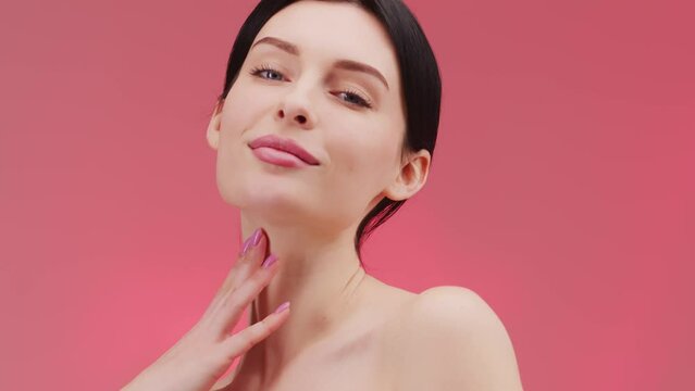 Beauty woman face isolated on pink background. Skin care. Beautiful female model with perfect clean fresh skin