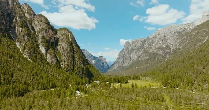 Aerial drone shot of the Dolomites alps with the pine forest in Italy, 4k