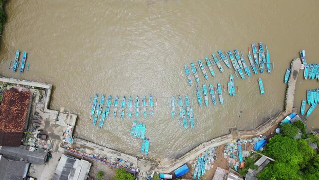 Overhead drone view of harbour with full of traditional fisherman boats - Baron Beach, Indonesia