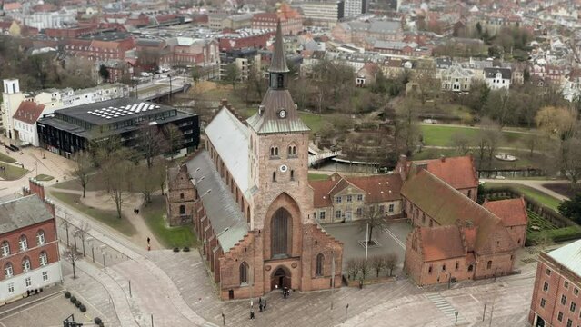 The building of the Odense Cathedral or St. Knud's Cathedral. The city's historical landmark is made of red brick, in the style of medieval Gothic with a high carved chapel with a long pointed spire