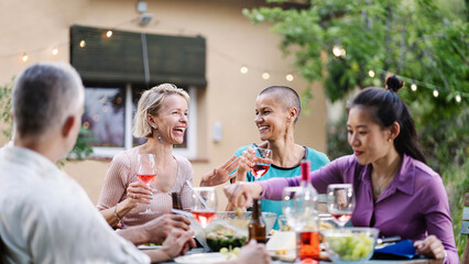 Women friends having fun at dinner, talking and eating healthy food, enjoying time together