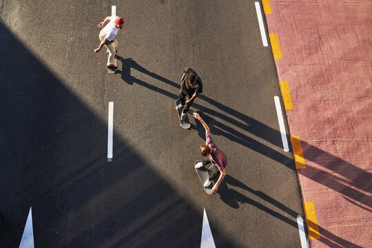 The best memories come from the craziest ideas. a group of skaters skating in the city.