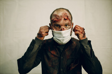 Zombie male makeup wearing medical face mask covering protection halloween party concept.
