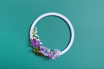 Spring composition. Lily of the valley and lilac flowers with round frame copy space. Summer,...