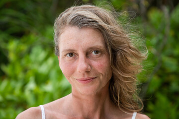 woman portrait and lush tropical greenery