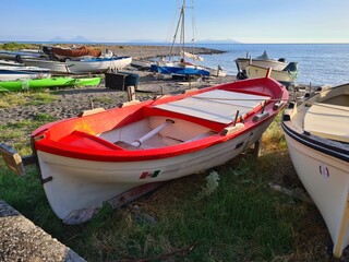 evocative close-up image of a fishing boat pulled ashore at the sea in 
a small fishing village in Sicily, Italy