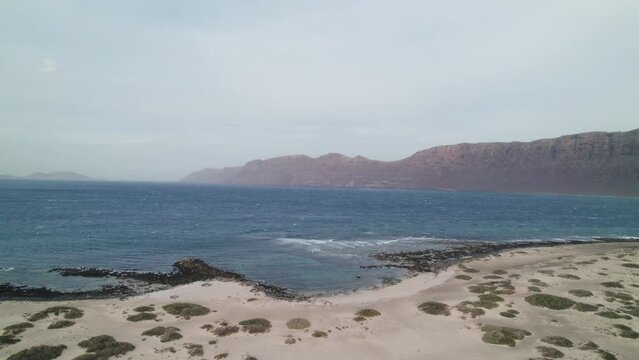 Playa de San Juan in Lanzarote, mountains over the sea