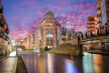 Sunset and brick buildings alongside a water canal in the central Birmingham, England