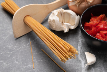 Fototapeta na wymiar Making dried, whole-wheat spaghetti and sauce with fresh ingredients.