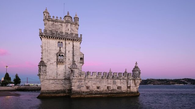 Belem Tower or Tower of St Vincent - famous tourist landmark of Lisboa and tourism attraction - on the bank of the Tagus River (Tejo) with tourist boats after sunset in dusk twilight. Lisbon, Portugal