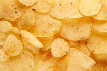 Potato chips texture background. Crispy and crunchy snack with a spicy kick
