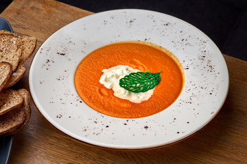 Pumpkin soup with cream. Close up. Healthy tasty food.