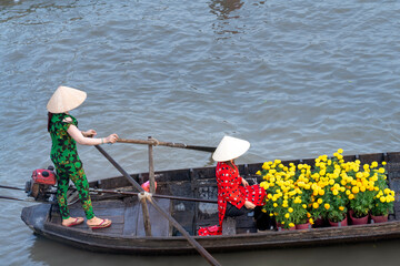 The scene of buying and selling the goods at a floating market with crowded boats carrying...