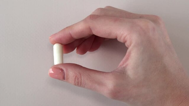 Vitamin D3 plus K2 in a woman's hand one capsule