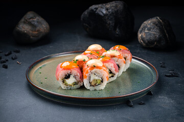 Sushi rolls set with salmon, tuna, Philadelphia cheese, avocado, mango sauce, spicy sauce.