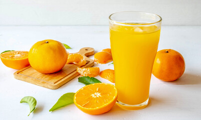 Freshly squeezed orange juice and orange fruit cut in half