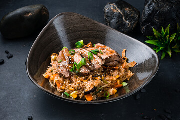 Rice with duck pieces, scrambled eggs, shiitake mushrooms and vegetables.
