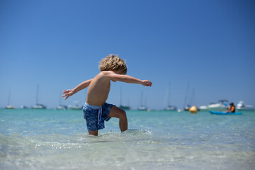 Young boy playing at beach
